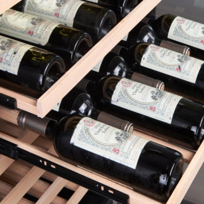 Sliding solid beech shelf of a Maison Vinum wine cellar holding two rows of Bordeaux bottles